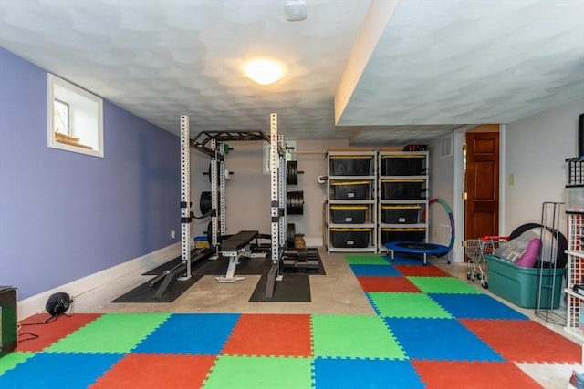 exercise room with baseboards