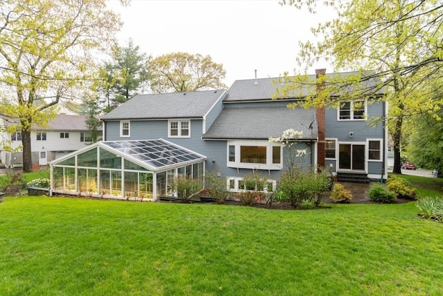 back of property with a lawn