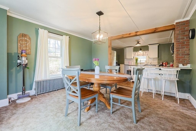 dining space featuring light colored carpet, ornamental molding, and radiator