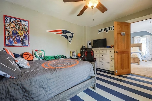 bedroom featuring ceiling fan and carpet