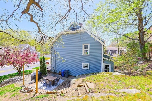 view of side of home featuring a patio area