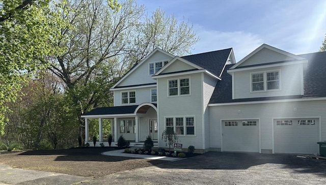 41 Winter St, Reading, MA 01867 - view of front of property with covered porch, an attached garage, driveway, and roof with shingles