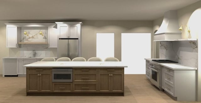 kitchen with custom exhaust hood, stainless steel appliances, tasteful backsplash, light countertops, and a sink