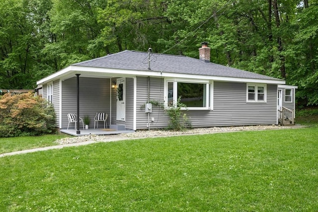 15 Dodge Hill Rd, Sutton, MA 01590 - view of front of property featuring a front lawn, a shingled roof, a chimney, and covered porch
