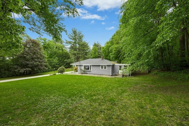 15 Dodge Hill Rd, Sutton, MA 01590 - back of property with a lawn and a chimney