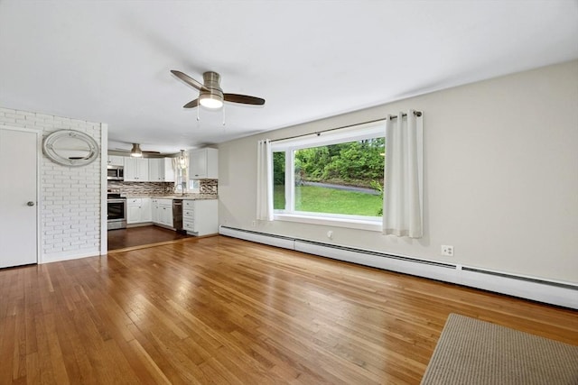 15 Dodge Hill Rd, Sutton, MA 01590 - unfurnished living room featuring dark wood-type flooring, a ceiling fan, and a baseboard radiator