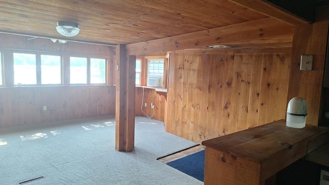 interior space with cooling unit, wooden ceiling, visible vents, and wood walls