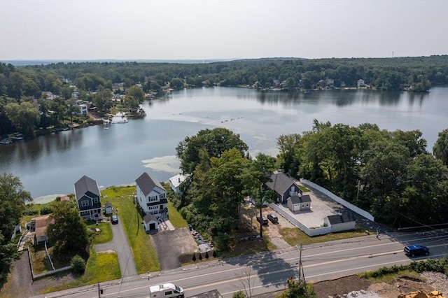 drone / aerial view featuring a water view and a view of trees