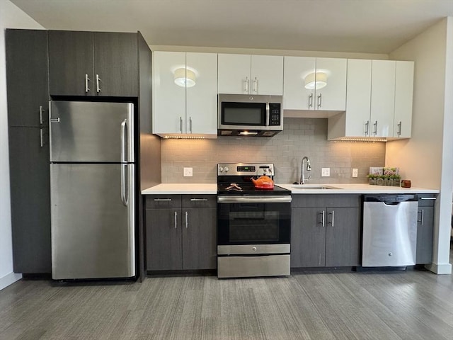 99 Tremont Unit 205, Boston, MA 02135 - kitchen with stainless steel appliances, light wood-style floors, light countertops, and white cabinetry
