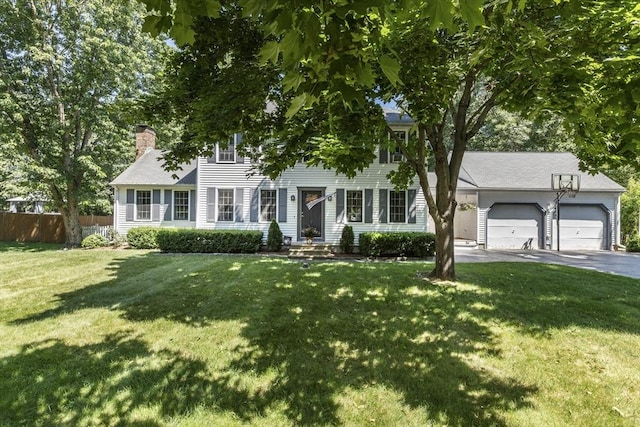 colonial home with a garage and a front yard