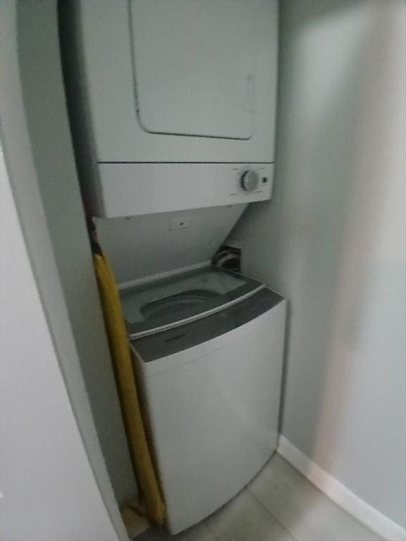 474 Revere Beach Blvd Unit 205, Revere, MA 02151 - washroom featuring stacked washer / drying machine, baseboards, and light tile patterned floors