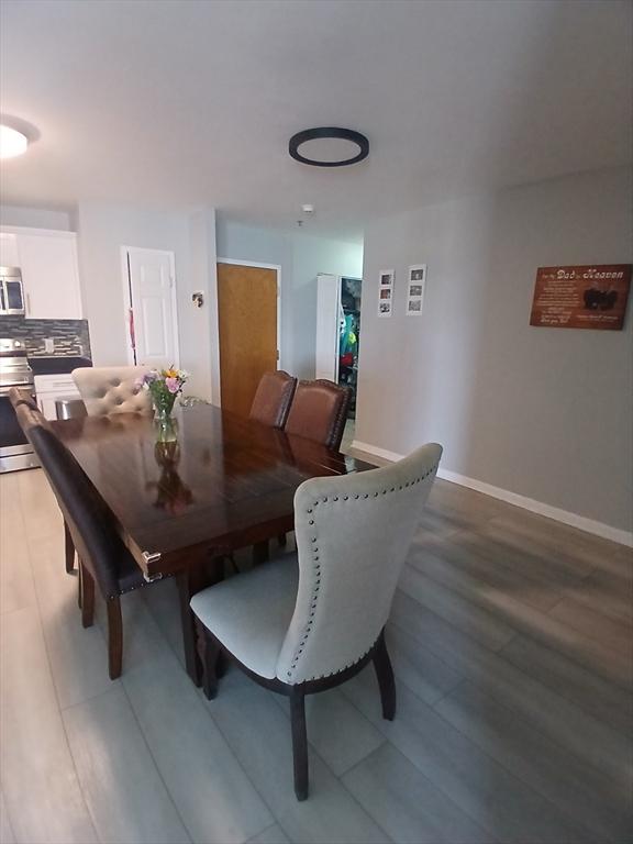474 Revere Beach Blvd Unit 205, Revere, MA 02151 - dining space featuring light wood-style flooring and baseboards
