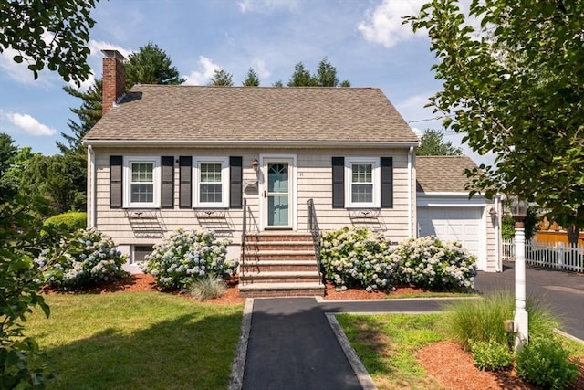 view of front of house with a garage and a front yard