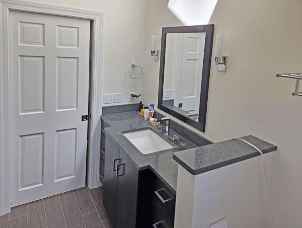 bathroom with vanity and wood tiled floor