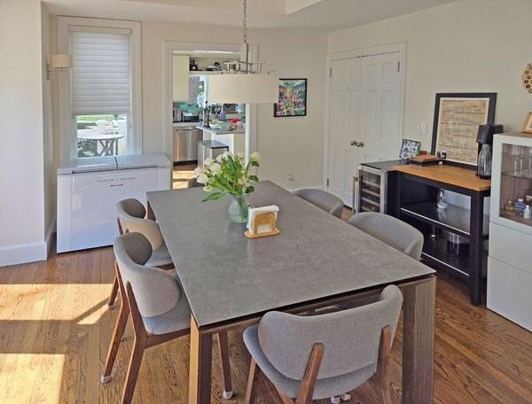 dining area with baseboards and dark wood-style floors
