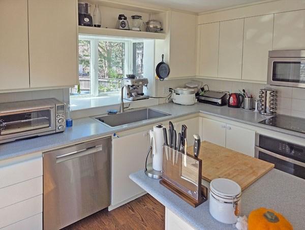 kitchen featuring light countertops, a sink, white cabinetry, and stainless steel appliances