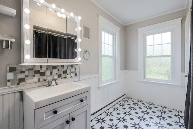 24 Tampa St, Worcester, MA 01604 - full bathroom featuring a baseboard heating unit, wainscoting, healthy amount of natural light, tile patterned floors, and ornamental molding