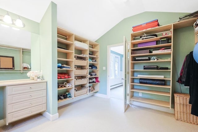 walk in closet with a baseboard radiator and lofted ceiling