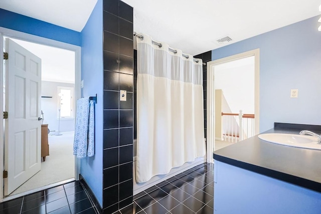 bathroom featuring vanity, tile patterned floors, visible vents, and shower / bathtub combination with curtain