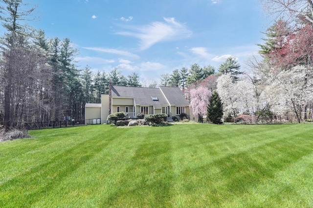 rear view of house with a yard