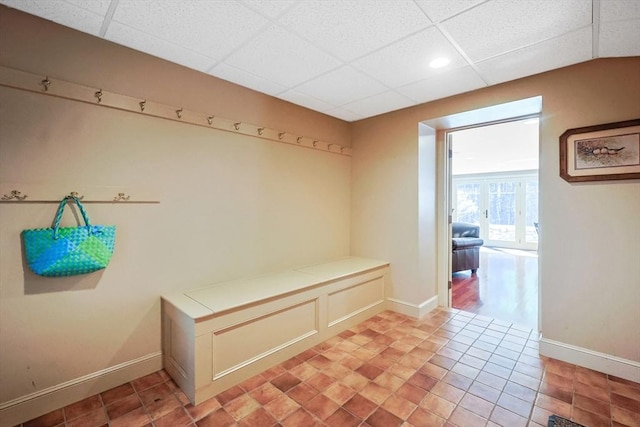 mudroom with baseboards, a drop ceiling, and recessed lighting