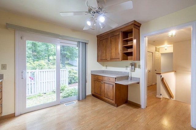 87 Fifer Ln Unit 87, Lexington, MA 02421 - kitchen featuring brown cabinets, light countertops, light wood-type flooring, and a ceiling fan
