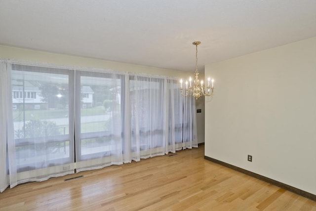 27 Chestnut Hill, South Hadley, MA 01075 - spare room with a chandelier and light wood-style floors