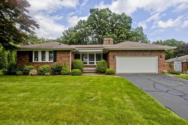 27 Chestnut Hill, South Hadley, MA 01075 - ranch-style home with a front yard, driveway, a garage, brick siding, and a chimney