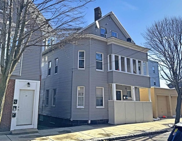 view of front facade with a chimney