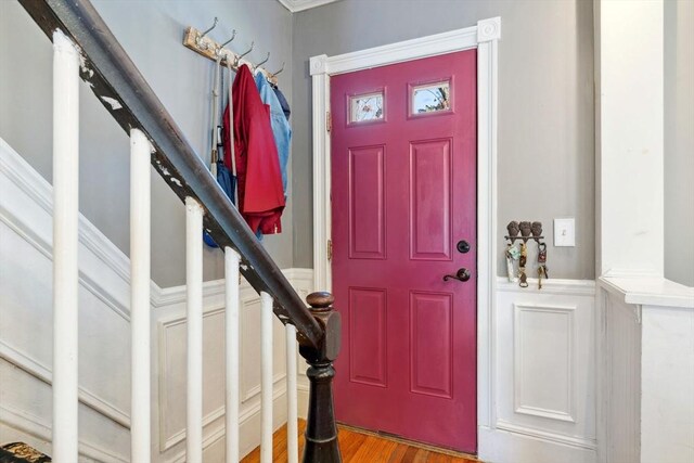 foyer entrance with stairs and wood finished floors