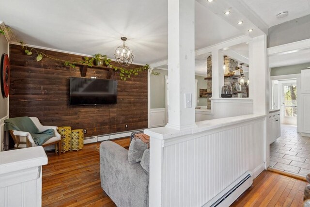 living room with a notable chandelier, hardwood / wood-style flooring, and a baseboard radiator