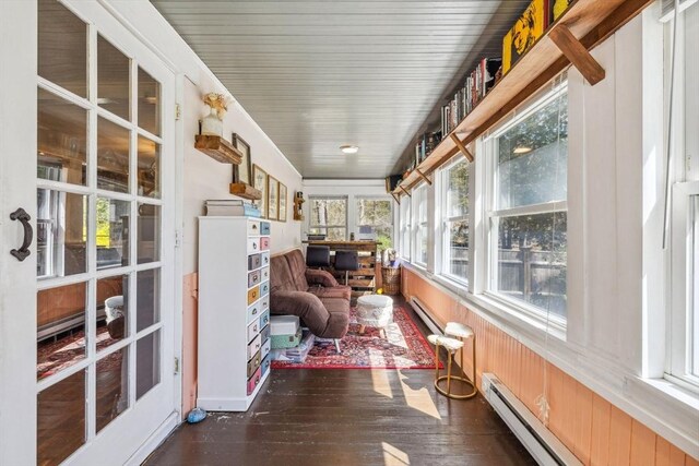 sunroom featuring baseboard heating and hardwood / wood-style floors