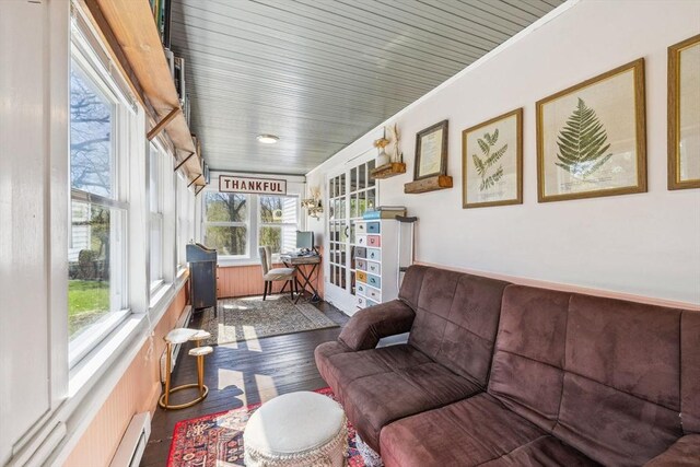 sunroom / solarium with crown molding and wood finished floors