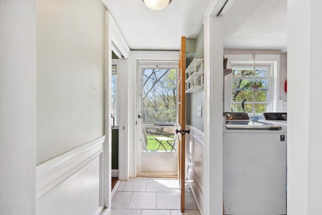 doorway with washer and dryer and light tile patterned floors