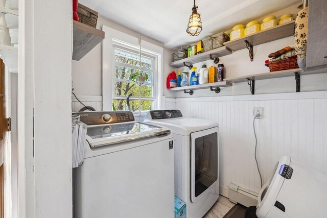 laundry area with baseboard heating, laundry area, wainscoting, and independent washer and dryer
