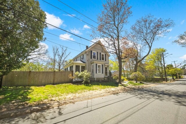 view of front of property featuring fence