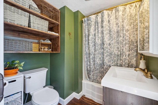 bathroom with baseboards, wood finished floors, toilet, and vanity