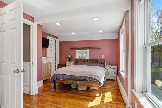 bedroom with light wood-type flooring, recessed lighting, multiple windows, and access to exterior