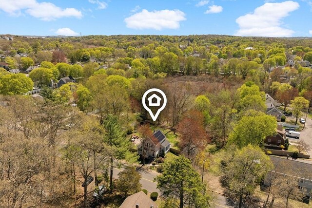 bird's eye view with a wooded view