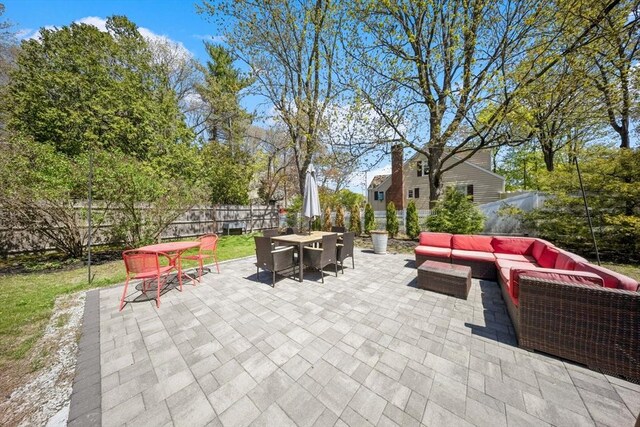view of patio / terrace featuring an outdoor living space, outdoor dining area, and a fenced backyard