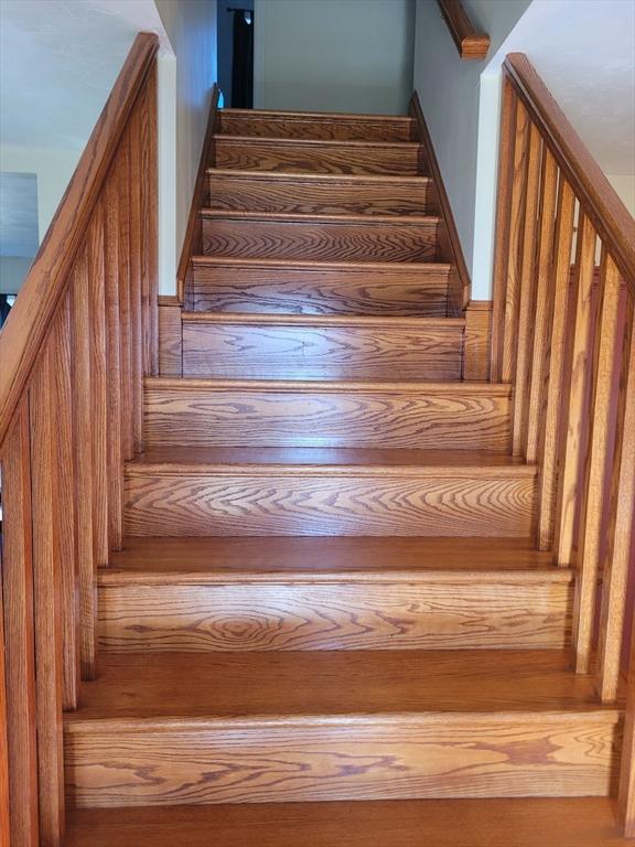 stairway featuring hardwood / wood-style floors