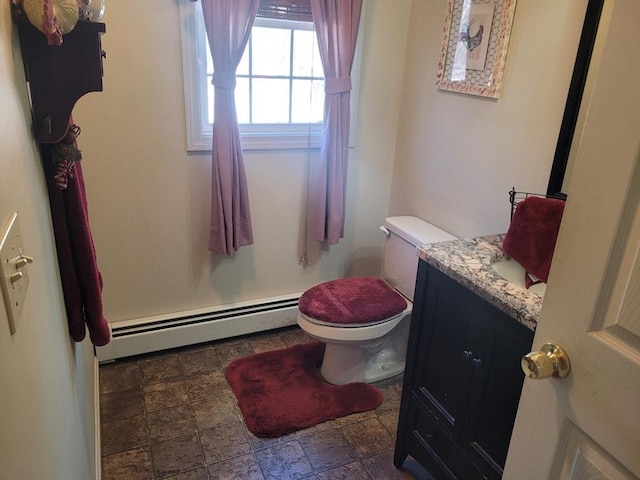 bathroom with a baseboard radiator, vanity, and toilet