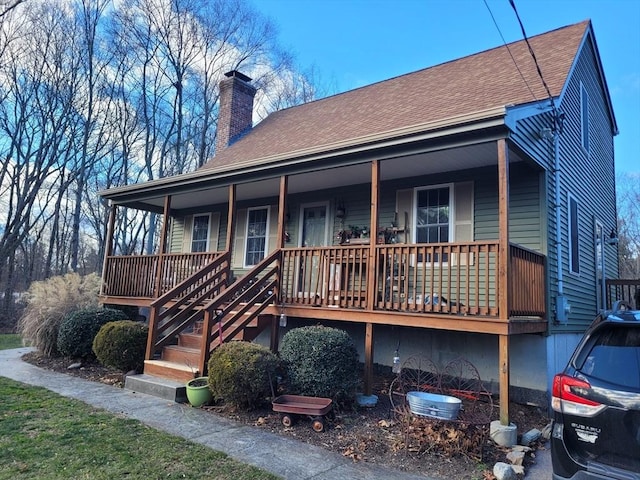 back of house featuring a porch