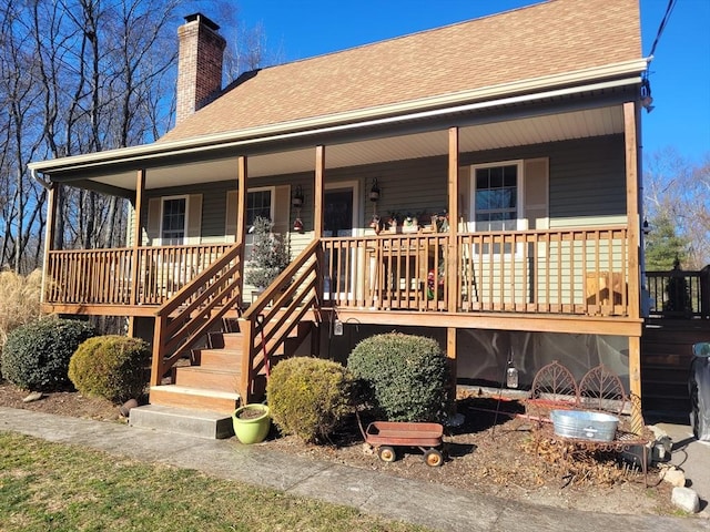 rear view of house featuring a porch