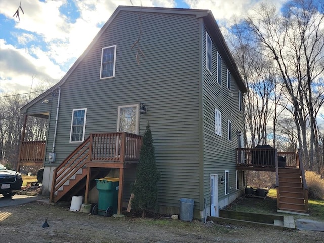 rear view of house featuring a wooden deck