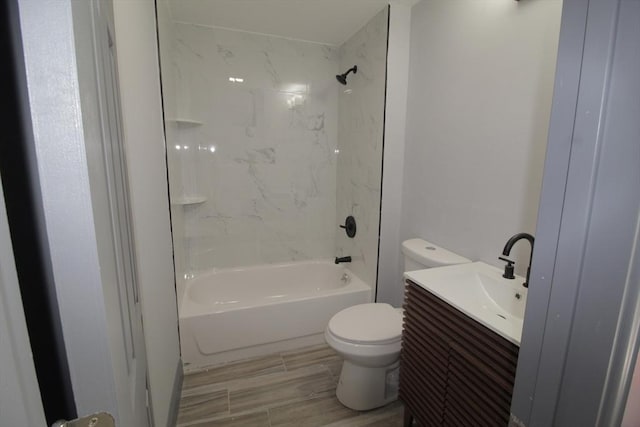 full bathroom with toilet, shower / washtub combination, wood finished floors, and vanity
