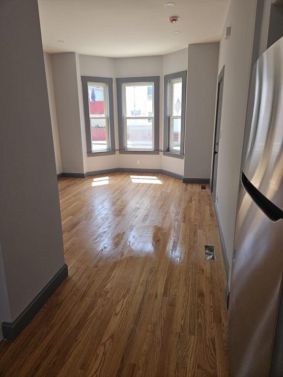 interior space featuring baseboards and wood finished floors