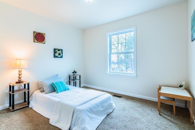 bedroom featuring visible vents, baseboards, and carpet