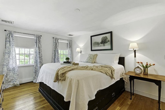 26 E St, Hopkinton, MA 01748 - bedroom featuring wood finished floors and baseboard heating