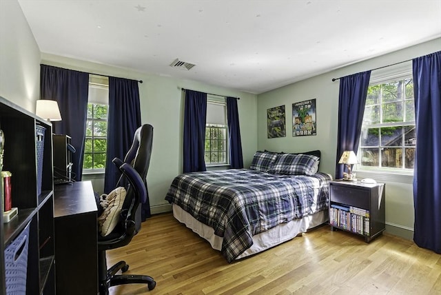 26 E St, Hopkinton, MA 01748 - bedroom with wood finished floors, baseboard heating, and a desk